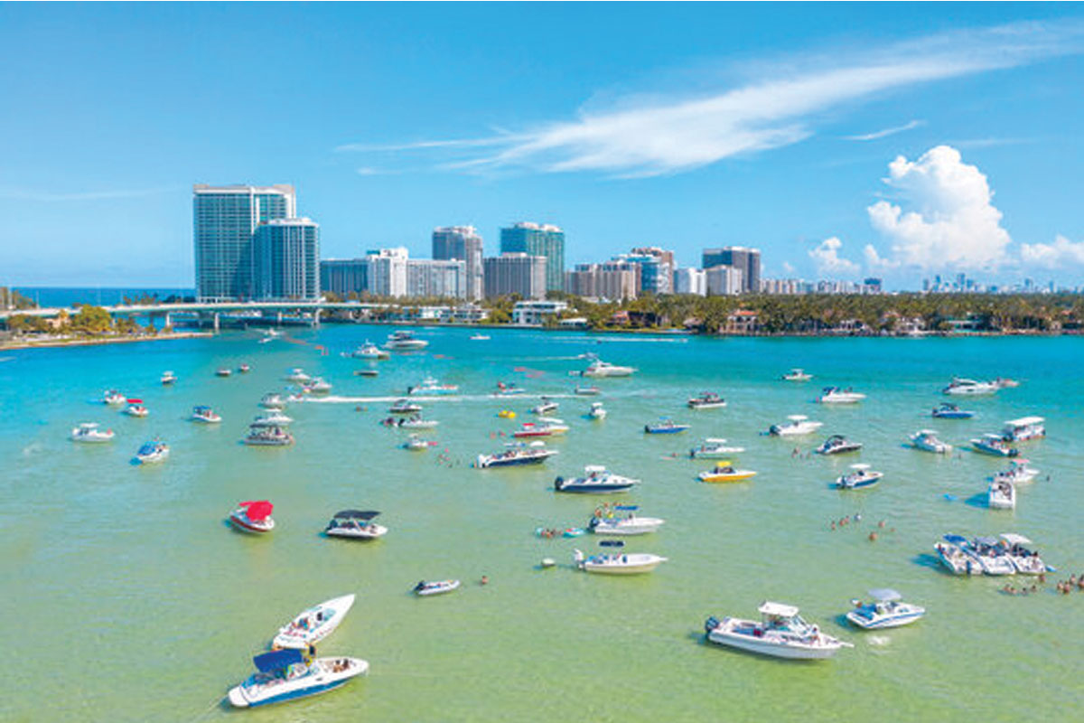 People kayaking and hanging out at the Haulover sandbar Miami on a day adventure boat tour
