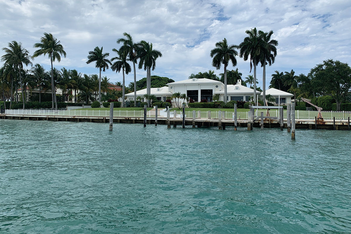 View of luxury waterfront homes on Indian Creek Island Miami from a sightseeing boat cruise